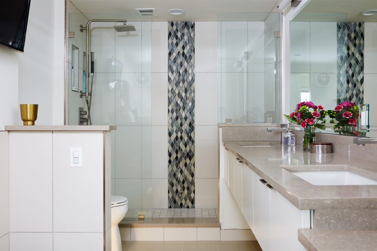 master bathroom floating vanity with double sinks separate shower with glass wall and mosaic tile stripe detail