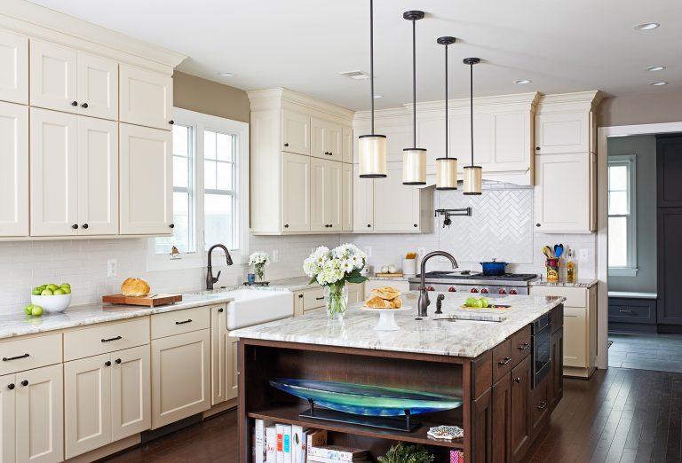 kitchen with white outer cabinets and dark cabinetry island with open shelving on side