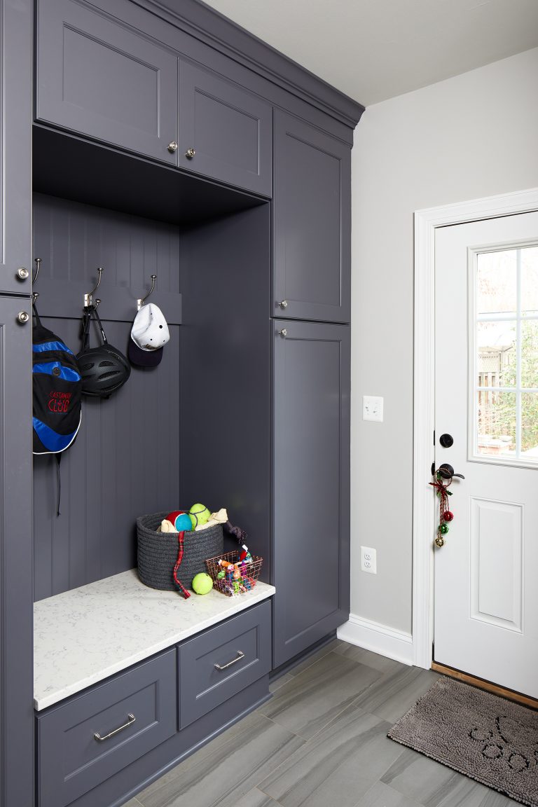 mudroom renovation gray floors grayish blue cabinetry storage and hooks