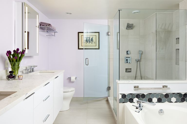 overview of bathroom storage nooks built into shower wall black and white tile detail around bathtub light purple walls