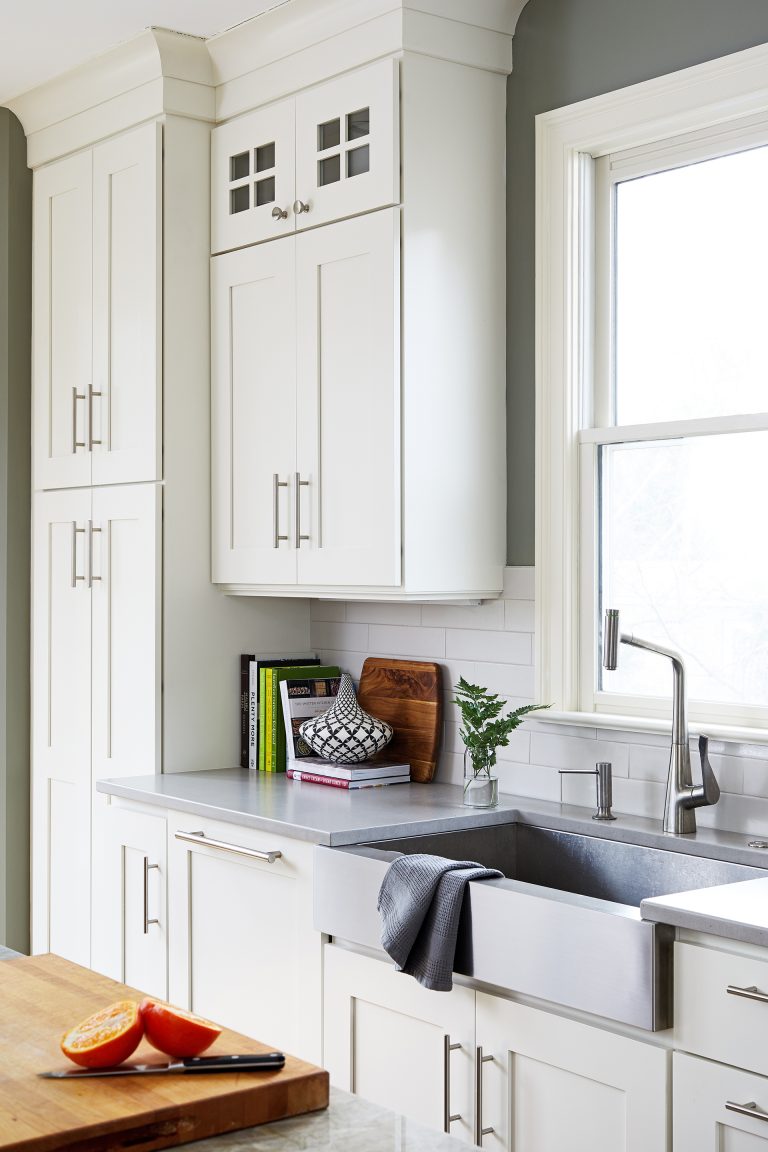 stainless steel apron sink in front of window