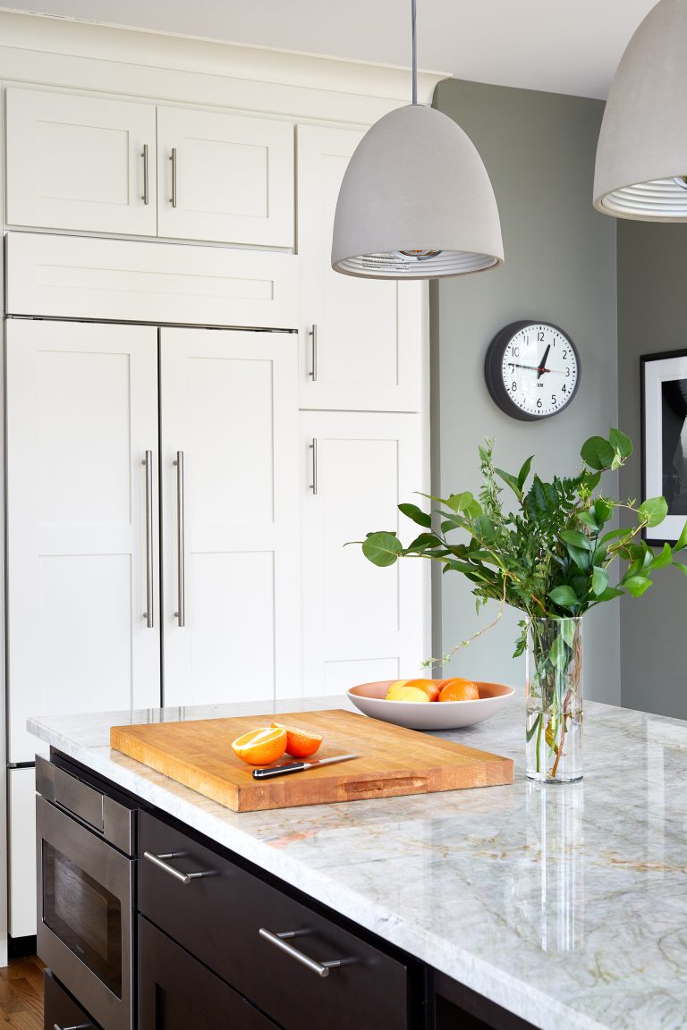 kitchen with sage green walls white outer cabinetry and paneled refrigerator