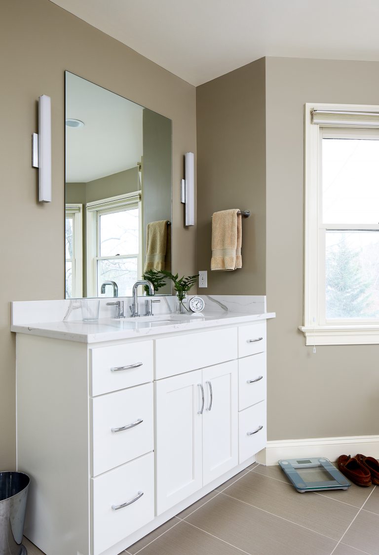 second vanity in master bathroom white cabinetry sconce lighting
