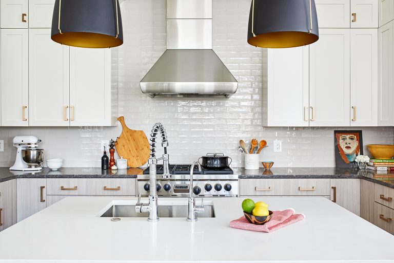 kitchen island with white countertops and pendant lighting above