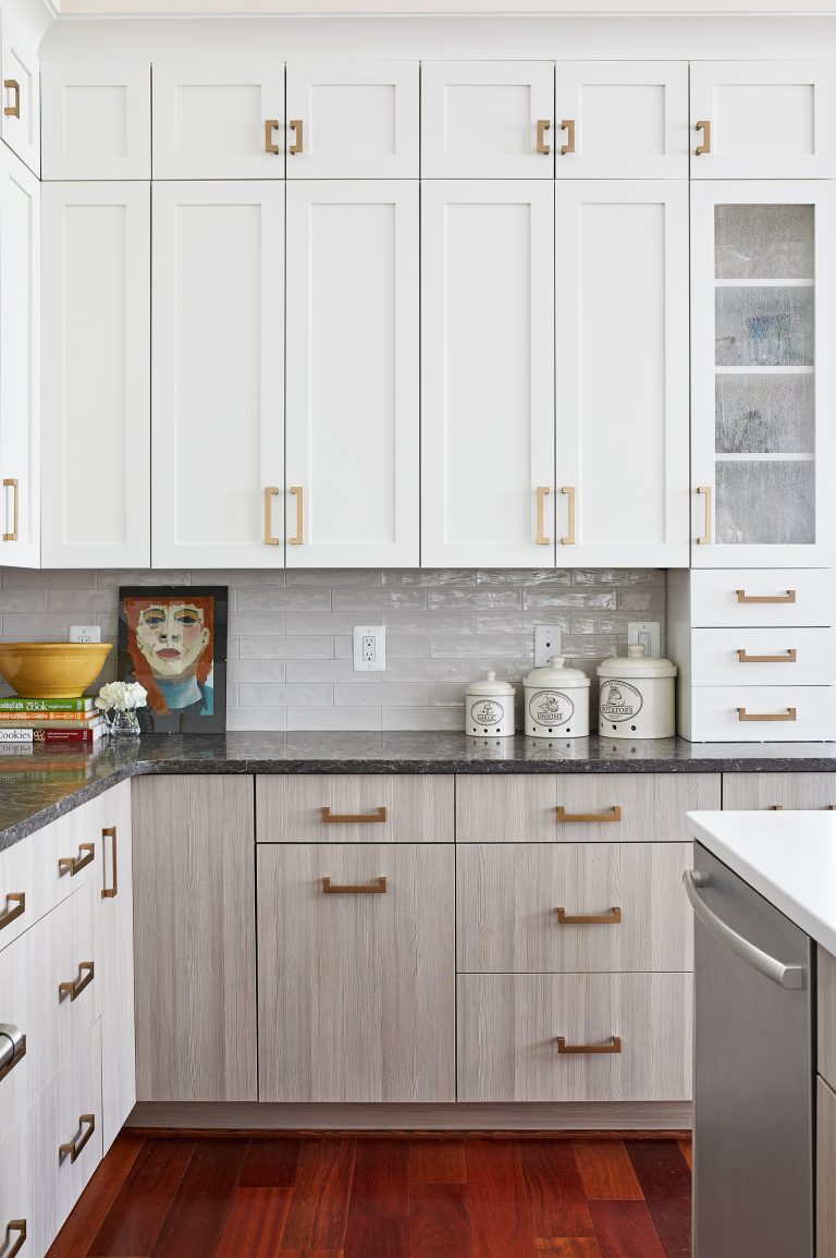 white upper cabinetry gray lower cabinetry gold hardware