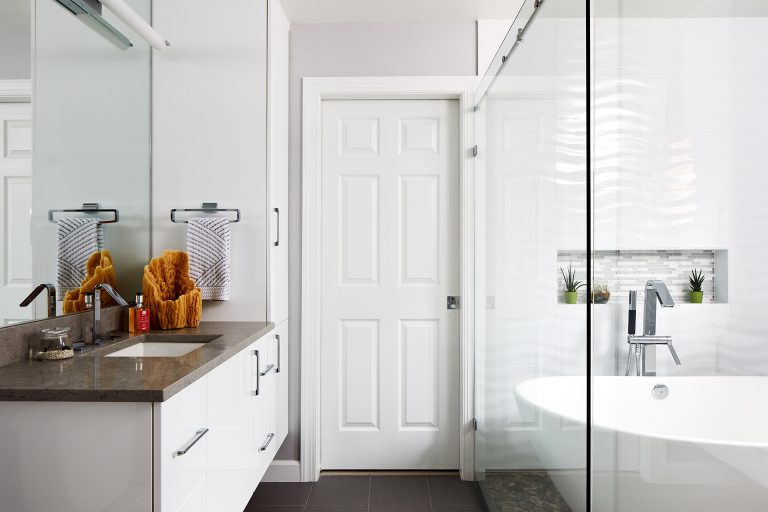 overview of bathroom bathtub and shower area divided by glass wall