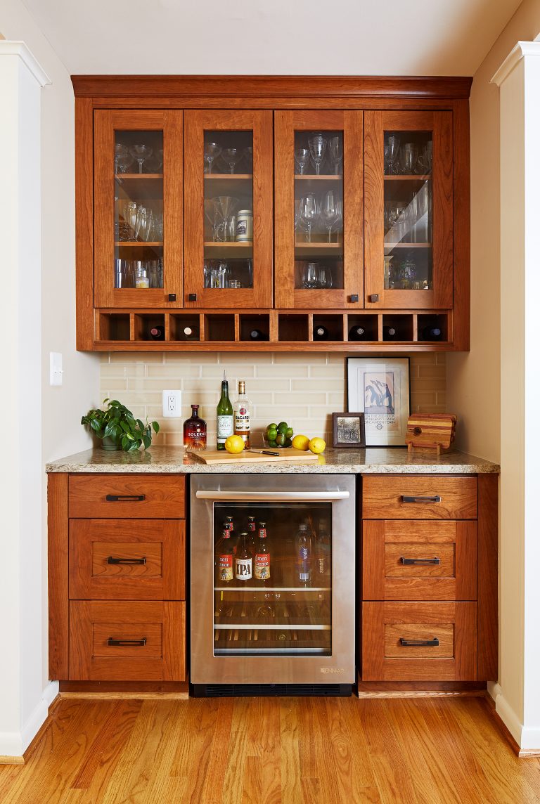 minibar area with beverage refrigerator glass door upper cabinets and wine storage