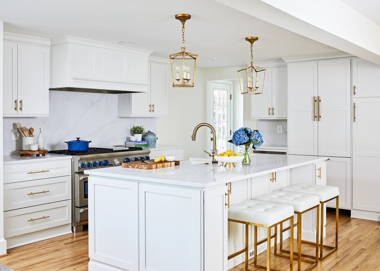 bright white kitchen with gold accents island with seating