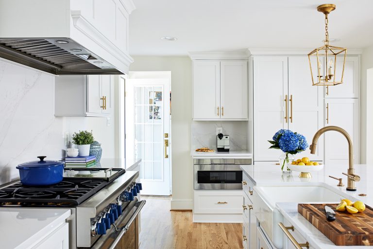 stainless steel gas range with blue knobs paneled range hood