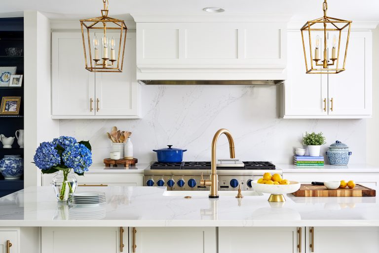 white cabinetry island with sink gold hardware and fixtures
