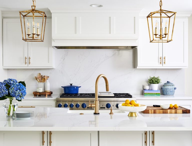 white cabinetry island with sink gold hardware and fixtures