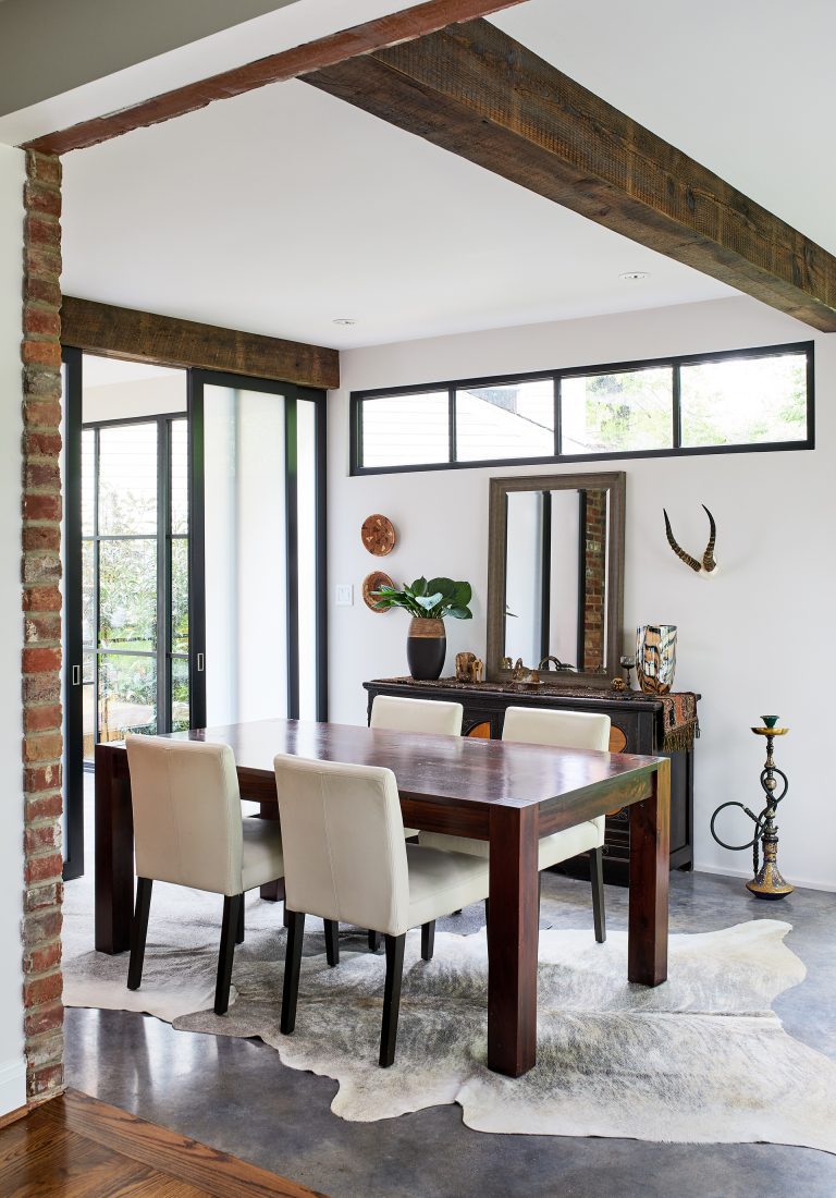 eclectic dining room design cement floors beam ceiling large glass doors with black frame