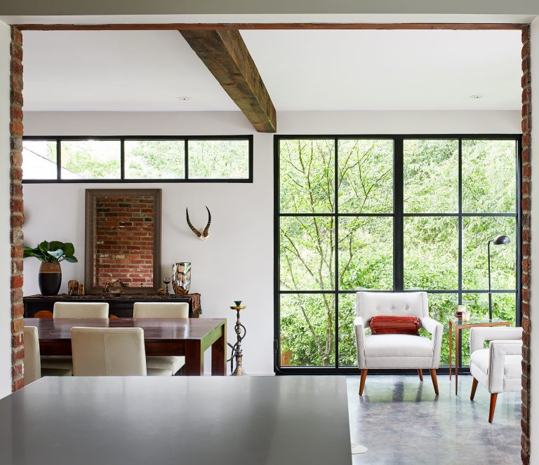 kitchen open living and dining room exposed beam ceiling large window with black pane