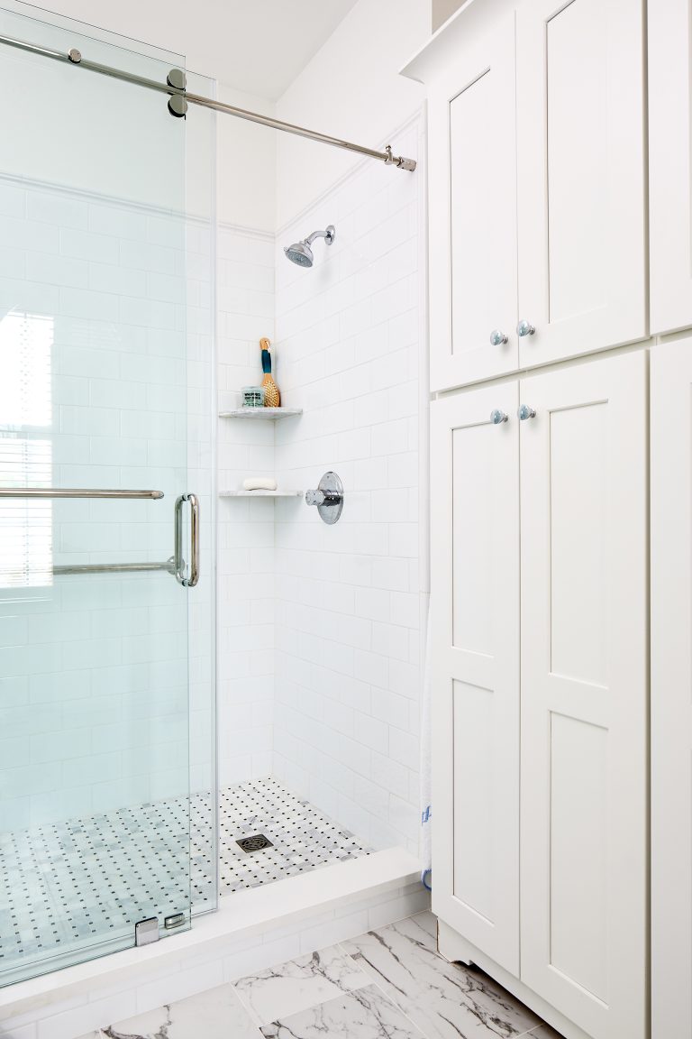 bathroom with tall linen storage cabinets in white
