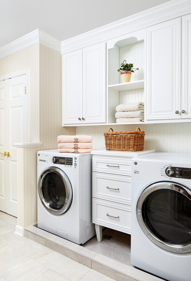 white modular laundry room storage set with accessories in white with some open shelving with basket