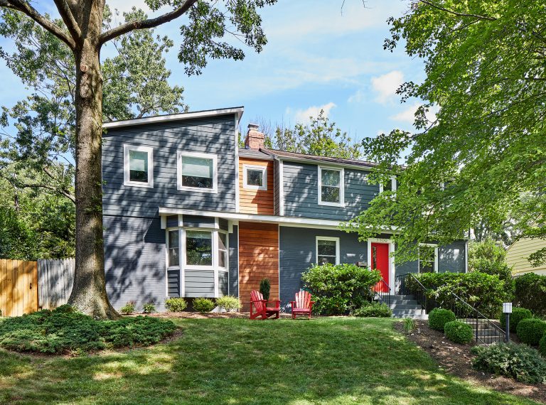 blue house with wood panel section and bay window modern design