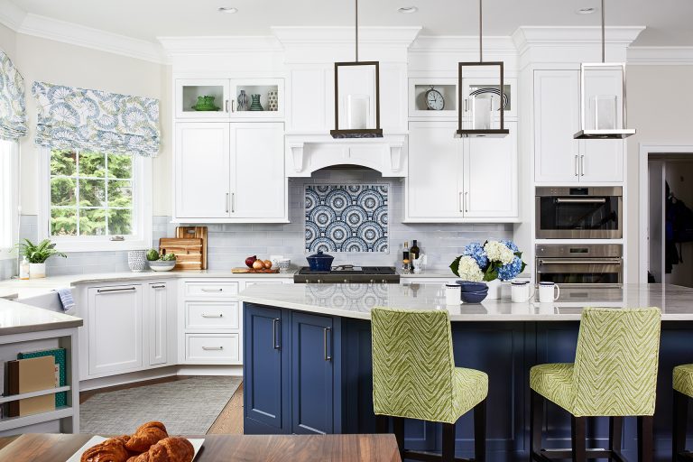 white kitchen cabinets with white and blue kitchen island, hard wood floors