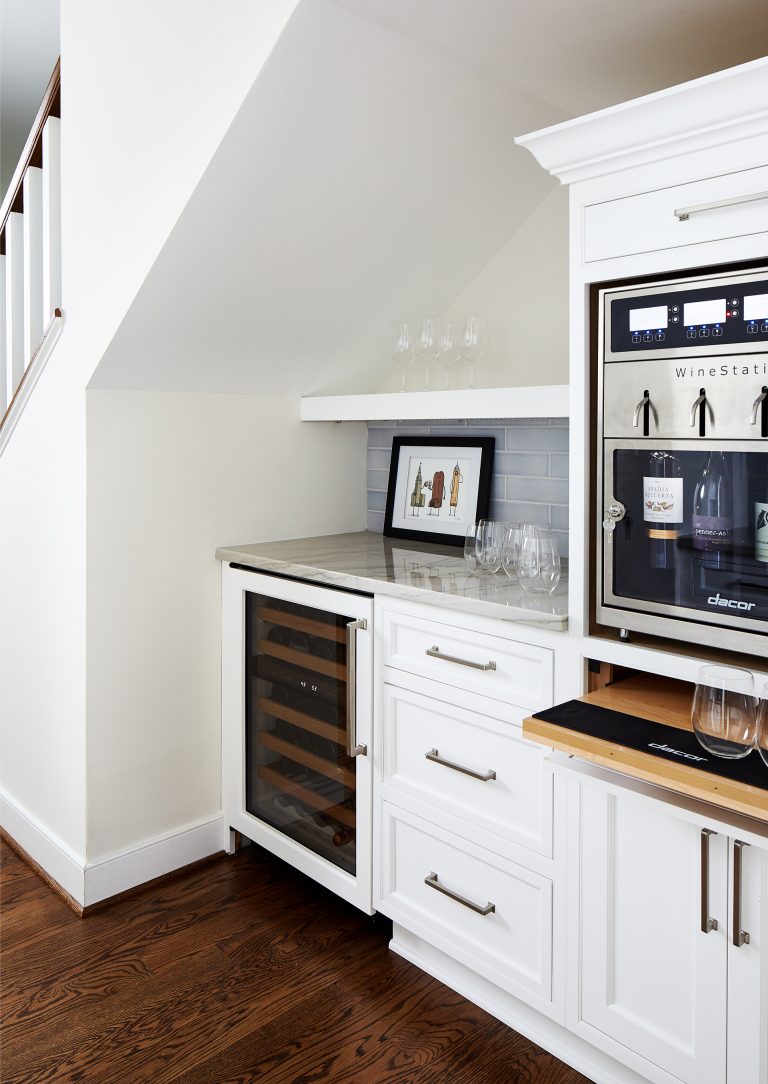 design build northern Virginia kitchen with side bar with white cabinets and subway backsplash with wine station and pull tray