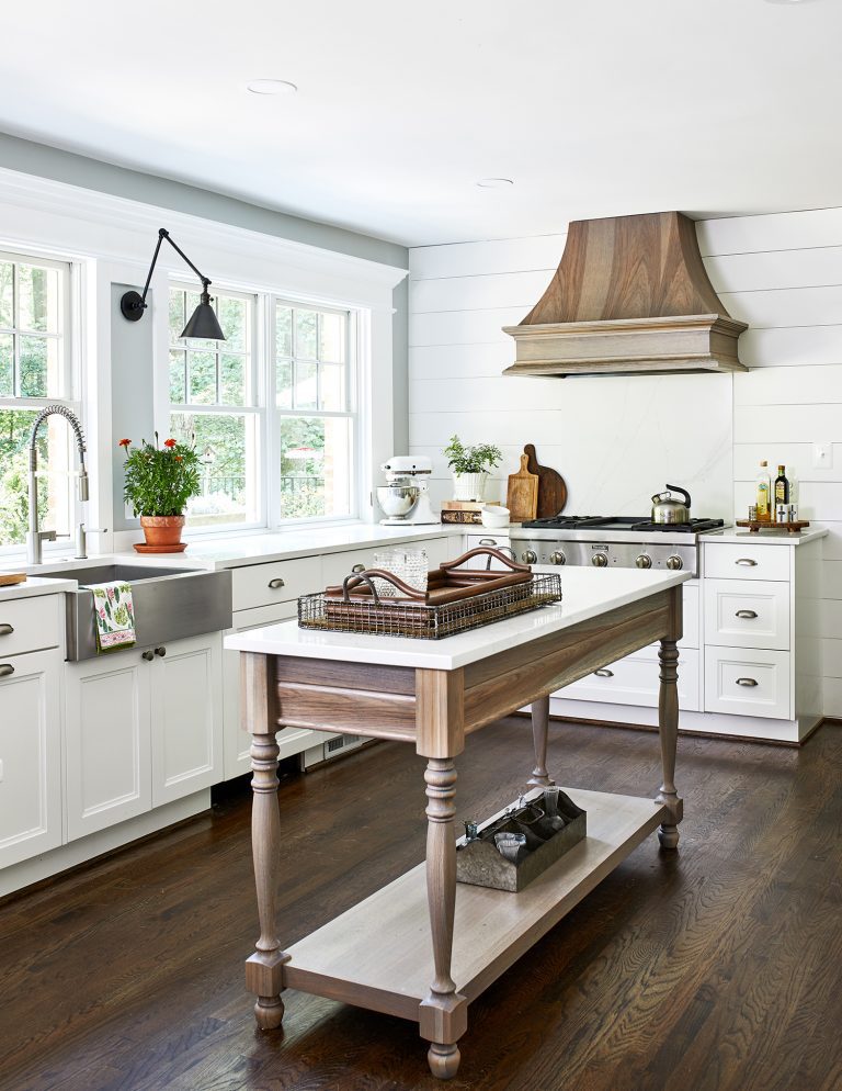 beachy wooden island with storage space and open shelf below the island