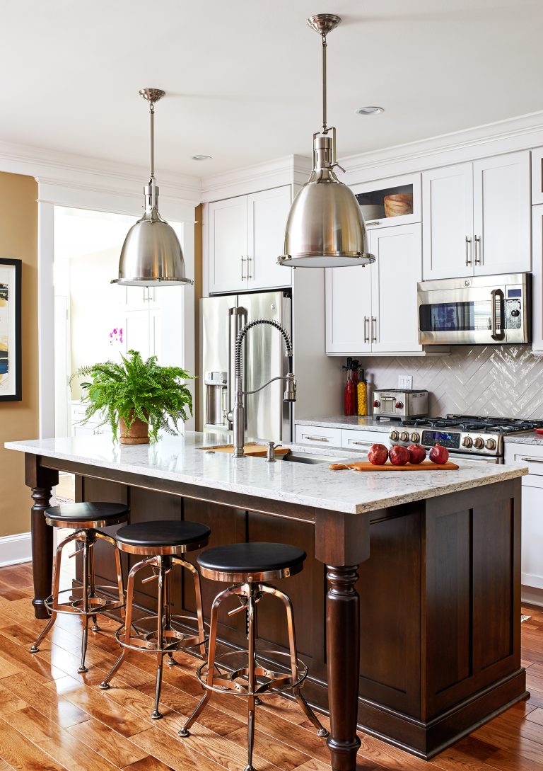 white and wood kitchen island with sink and seating, wood floors, kitchen cabinets refrigerator surround cabinets