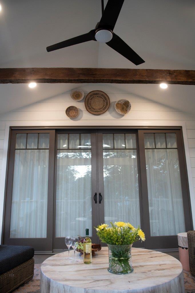 interior back patio sliding double glass doors and outdoor ceiling fan with lights