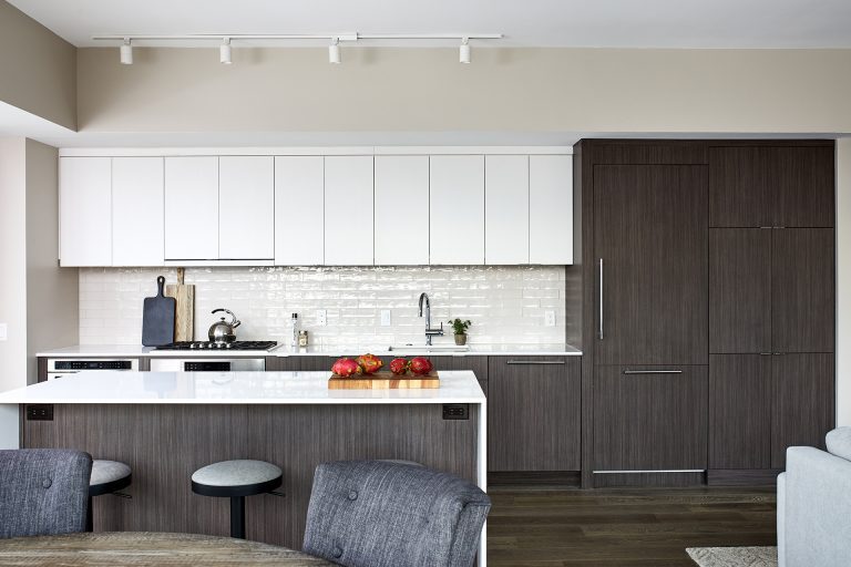 dc design kitchen with sleek and streamlined handless white cabinets with a flat smooth surface