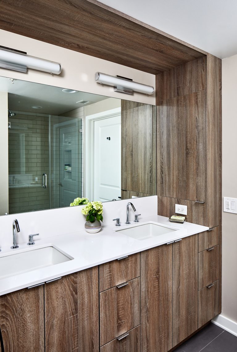 bathroom with double sink and vanity cabinet with two lights