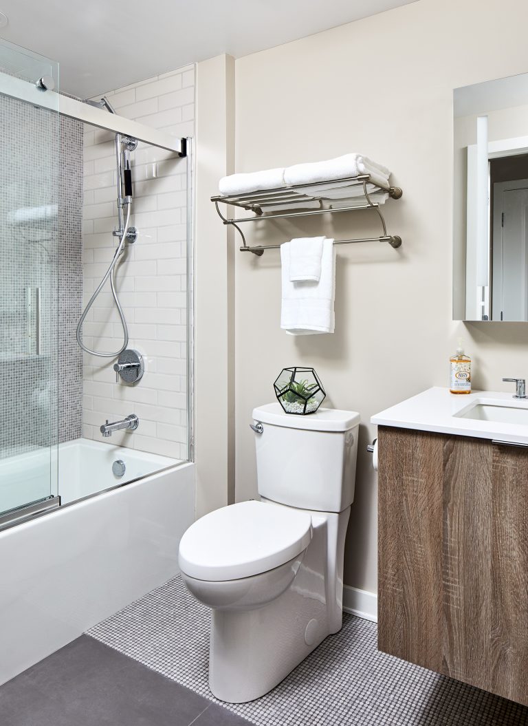 Bathroom with above the toilet storage shelf with single sink and rectangular mirror