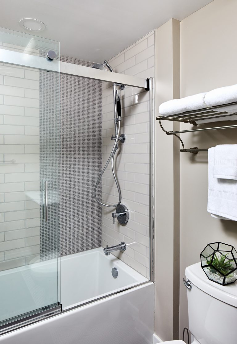 dc remodeler bathroom with clear semi framed sliding glass door with chrome shower head