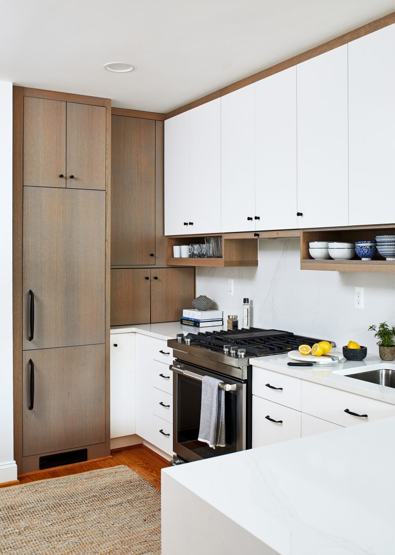 Dc home remodeler kitchen with brown tall wooded cabinets storage with black pull handles and knobs