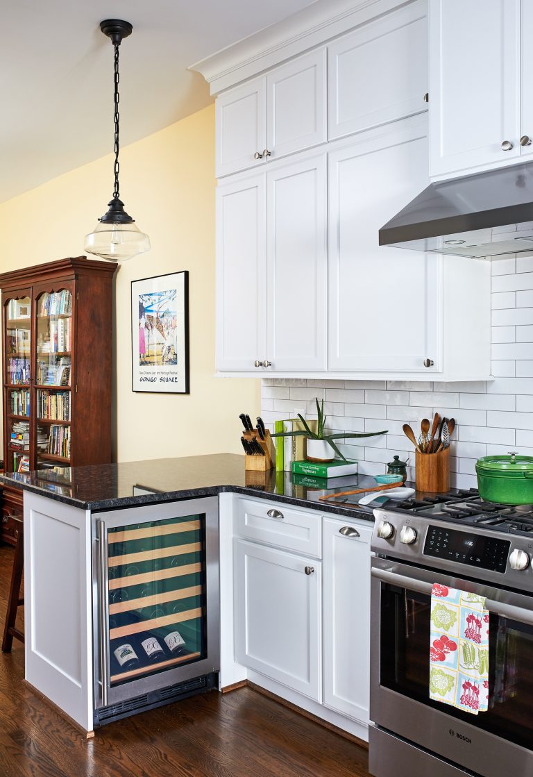 hanging light above black counter with small wine chiller cabinet mini fridge