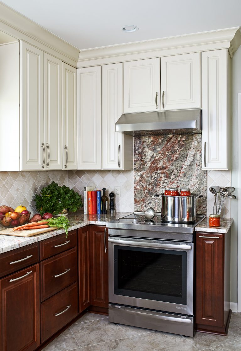 Traditional kitchen backsplash with stainless steel stove and hood range
