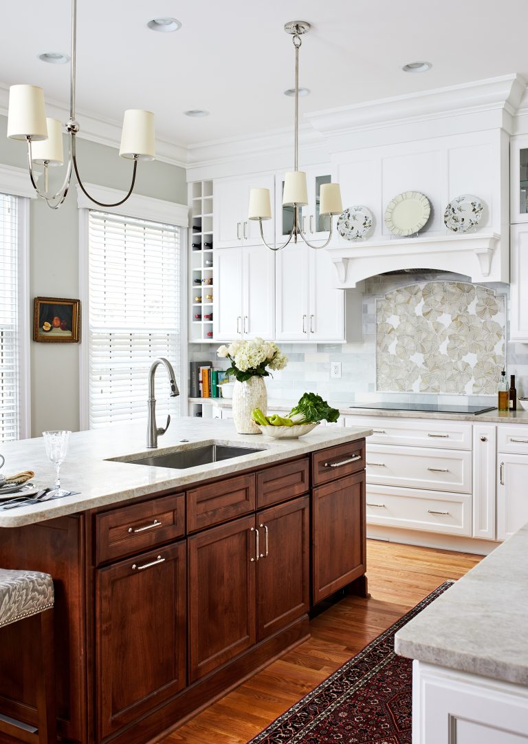 kitchen remodeling cabinetry hood with marble top island wooded floors and pendant lamps