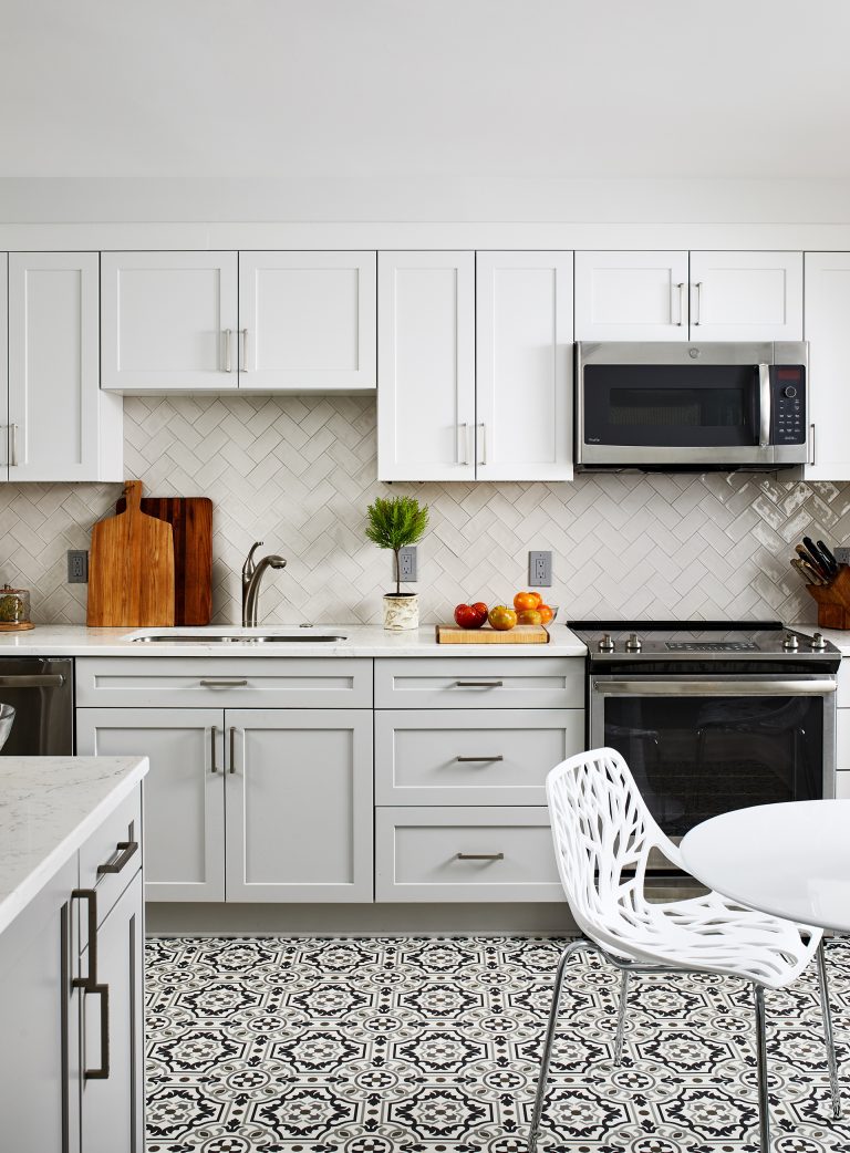 Built in microwave with lots of cabinets space and white marble kitchen island