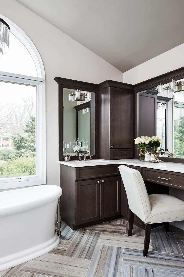 dark-colored finishes wood brown cabinets with large vanity with two mirrors