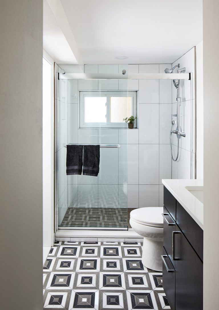 case design build bathroom with bypass glass sliding shower door in chrome