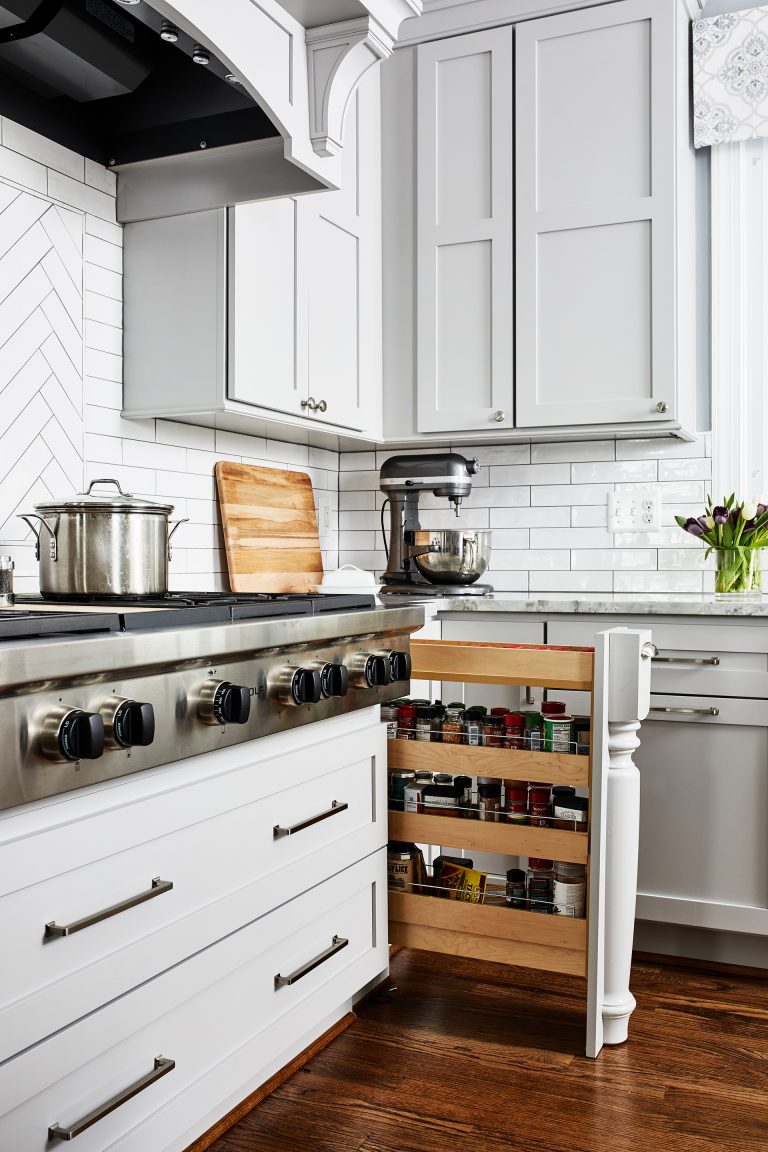 traditional design kitchen white cabinets with hidden spice rack next to stove