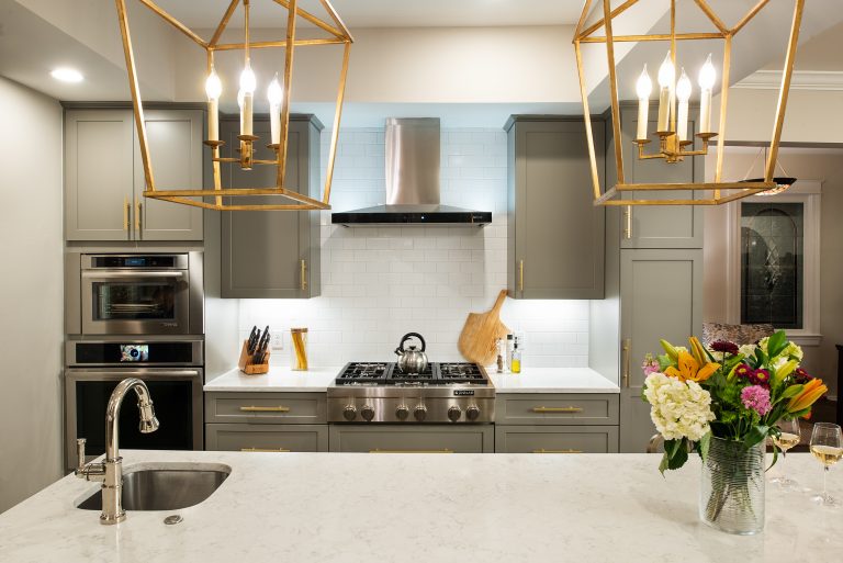 Large kitchen island with above gold light fixtures