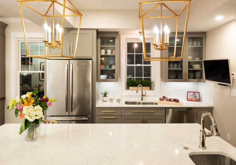 kitchen remodel dc with hanging gold lamps above island with extra sink