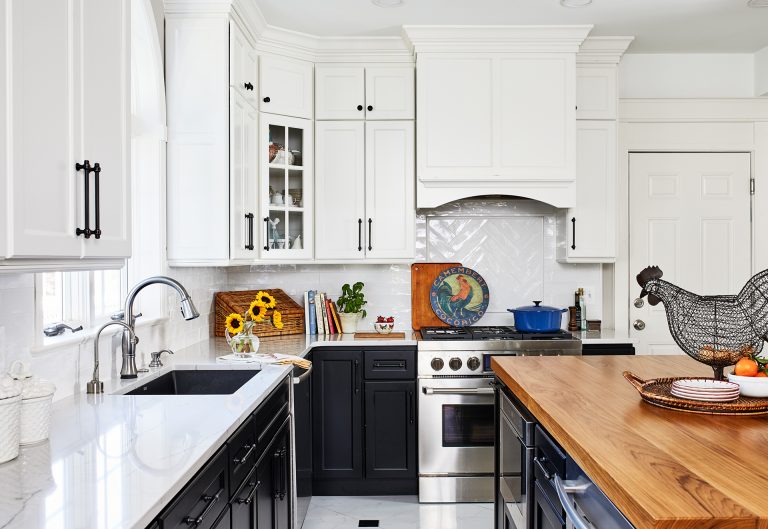 case kitchen design with white cabinets with black handles and white backsplash