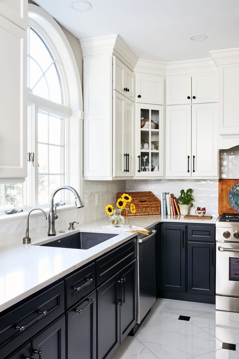 white and black kitchen cabinets window above large sink