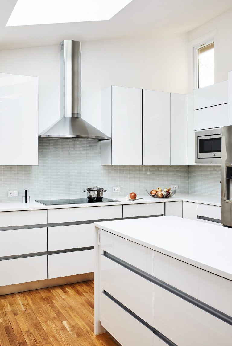 kitchen with wood flooring and stainless steel island mount range