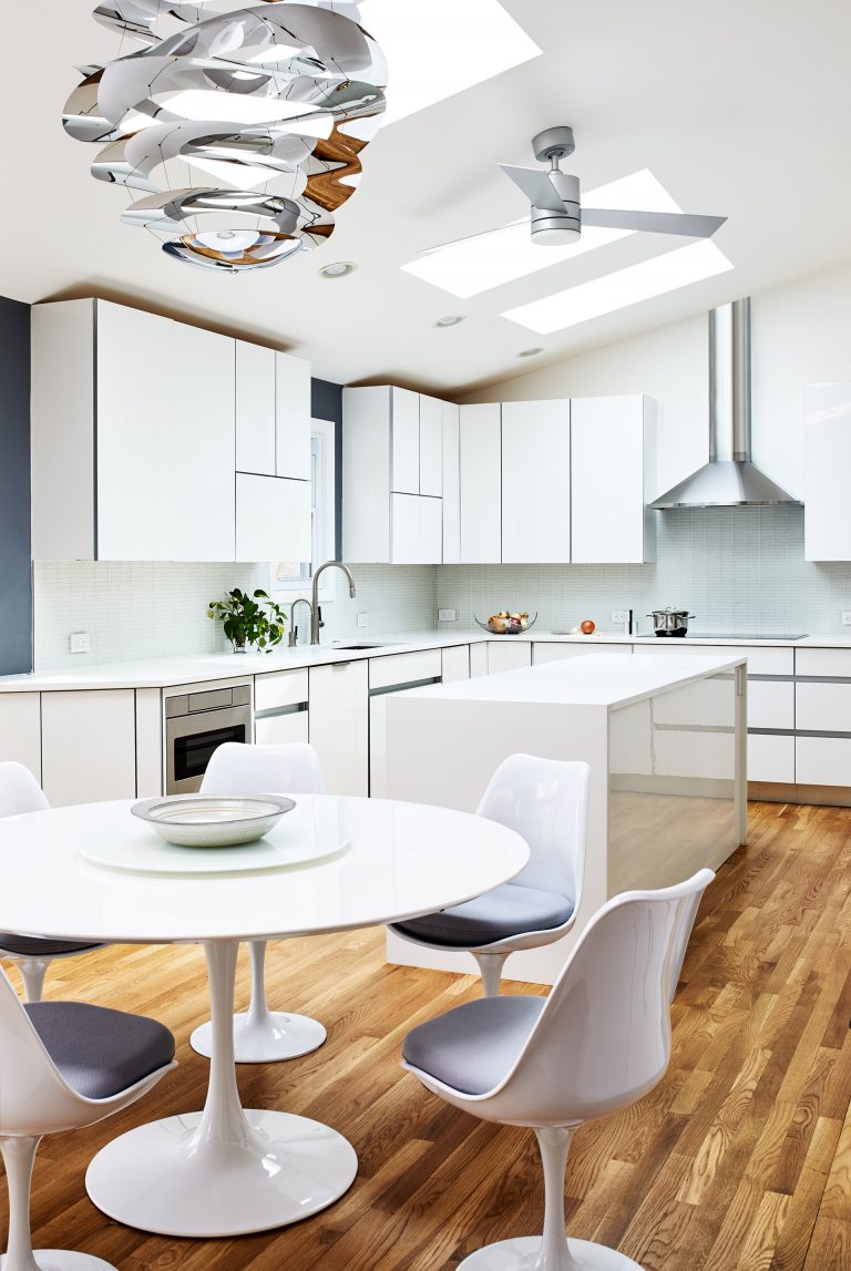 ceiling over a white kitchen island with round white table