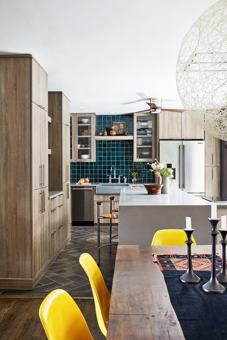 eclectic kitchen renovation with natural wood cabinetry and teal tiling