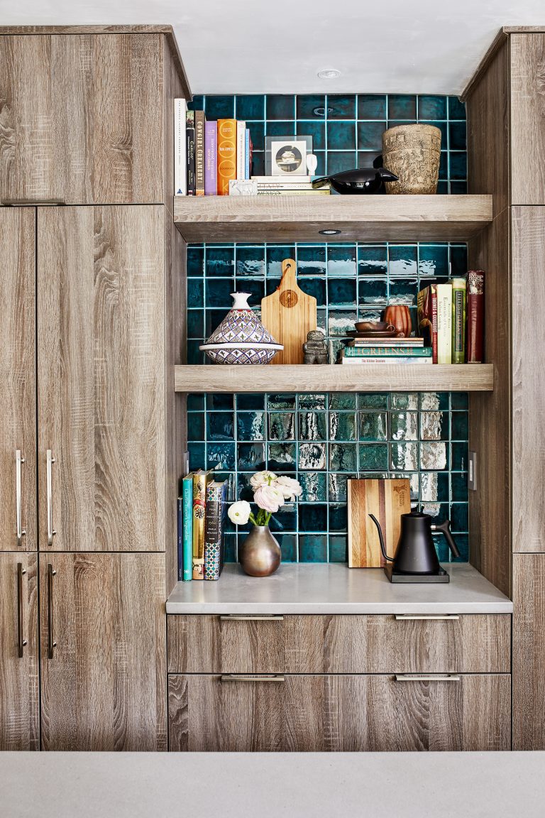 display and storage area with natural wood floor to ceiling cabinetry and open shelving