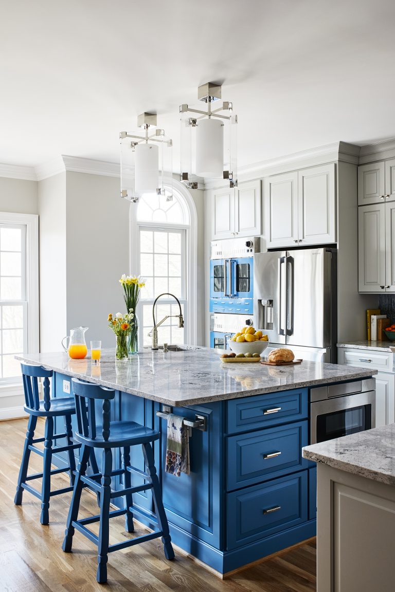 kitchen with island seating and blue cabinetry pendant lighting