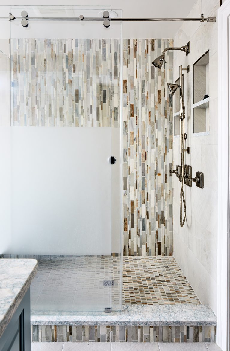 transitional Virginia remodel design bathroom walk-in shower on the corner and with frameless sliding shower door with 2- handle brass shower head