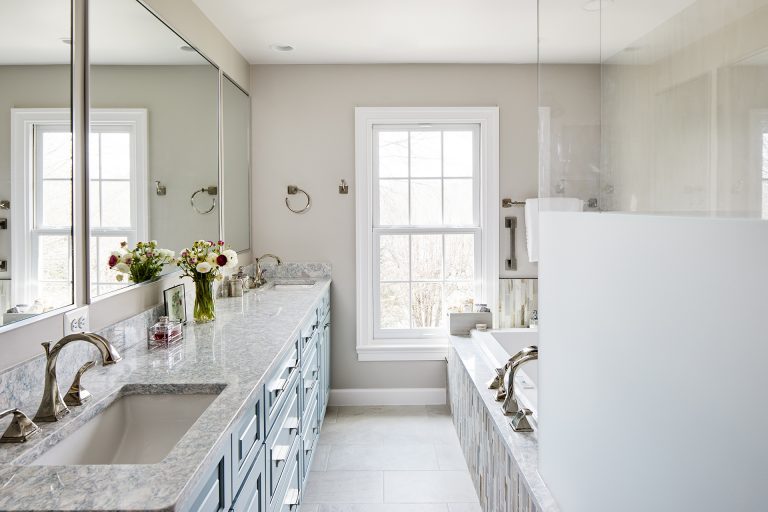 bathroom with marble counter tops with two sinks perfectly placed in between the shower room and the bathtub