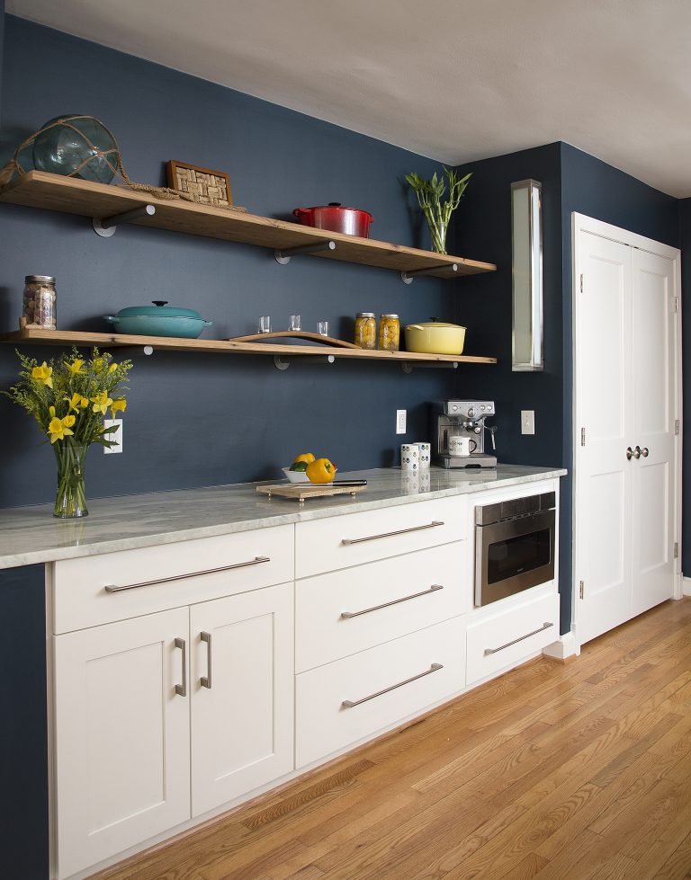 kitchen with navy walls white cabinetry open shelving