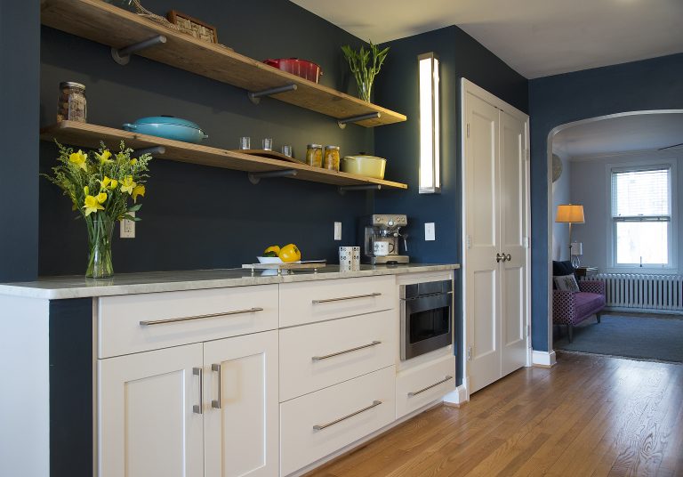 kitchen with navy walls white cabinetry open shelving
